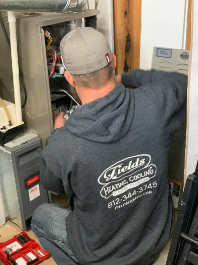 Jeremy Fields from Fields Heating, Cooling & Home Services repairs a customer's furnace